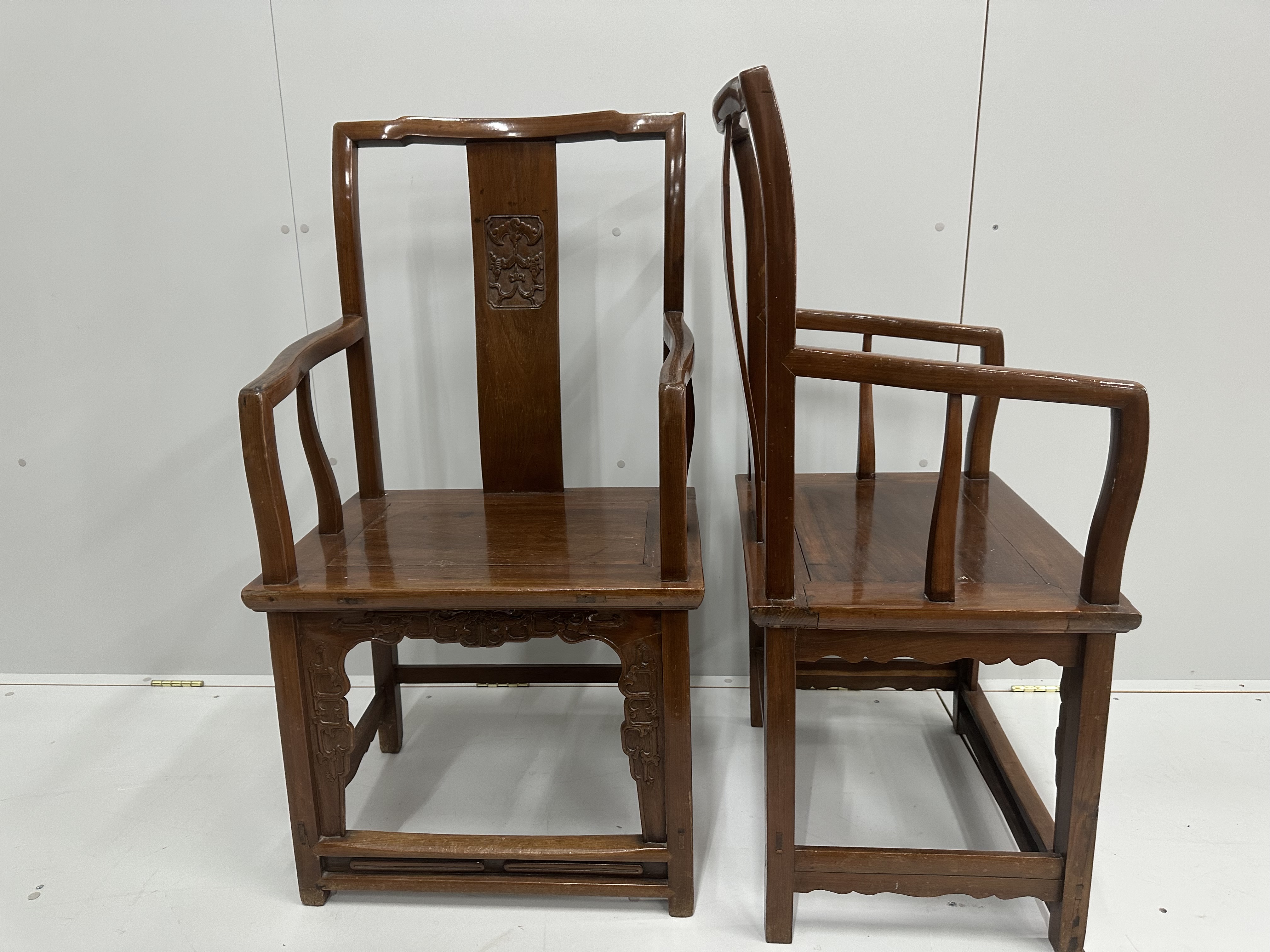 A pair of Chinese hardwood elbow chairs, width 56cm, depth 44cm, height 107cm